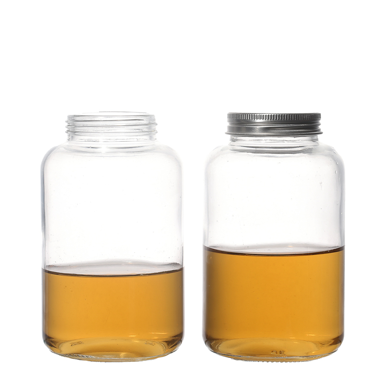 Botellas redondas de vidrio para bebidas con tapa con orificio de rosca